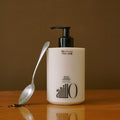 ANILLO Black Tea Nourishing Scalp Shampoo 450ml bottle with a spoon beside it.