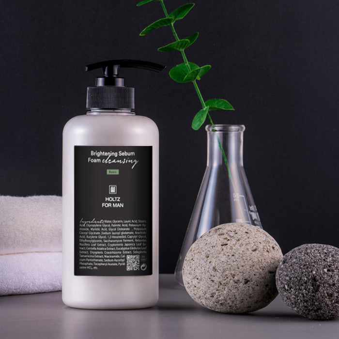 ANNA HOLTZ For Men Brightening Sebum Foam Cleansing 500ml bottle styled with towel, pumice stones and eucalyptus on Gentleman Korea product shot