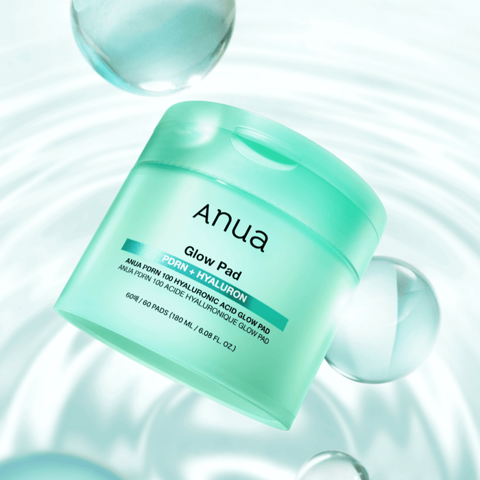 ANUA PDRN 100 Hyaluronic Acid Glow Pad in a mint green container, featured on a light reflective background.