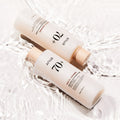 ANUA Rice 70 + Ceramide Glow Milky Toner 250ml bottles submerged in water