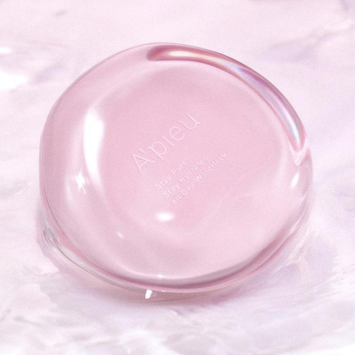 A'PIEU Waterlock Comfort Veil Cushion 15g in pink, floating on water, showcasing its sleek, reflective design.