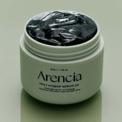 Open jar of ARENCIA Fresh Holly Hyssop Serum 30 50g on a reflective surface