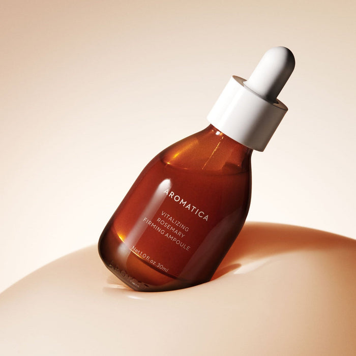 Bottle of AROMATICA Vitalizing Rosemary Elasticity Ampoule 30ML against a soft background.