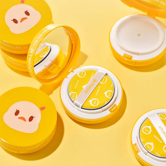 ATOPALM Toktok Facial Sun Pact SPF43 PA+++ 15g compact on yellow background with cushion and mirror