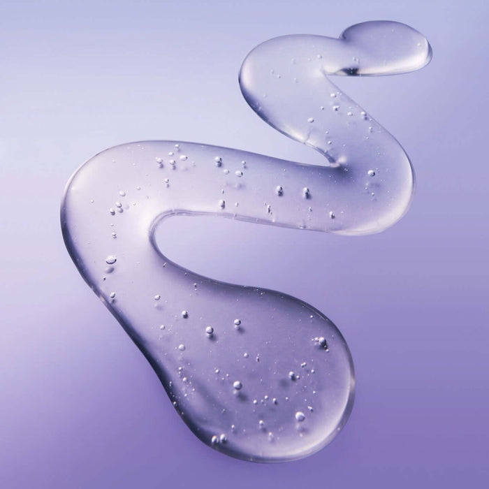 Texture of BELIF Numero 10 Essence 75ml skincare product with purple hue and droplets