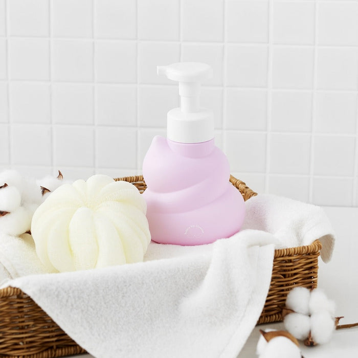 BELLBOY STUDIO Hippong Bubble Butt Cleanser bottle in a wicker basket with cotton and towels, showcasing bathroom decor and product display.
