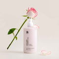 BENTON Ceramide Calming Ato Body Lotion 300ml beside a pink rose on a white background.