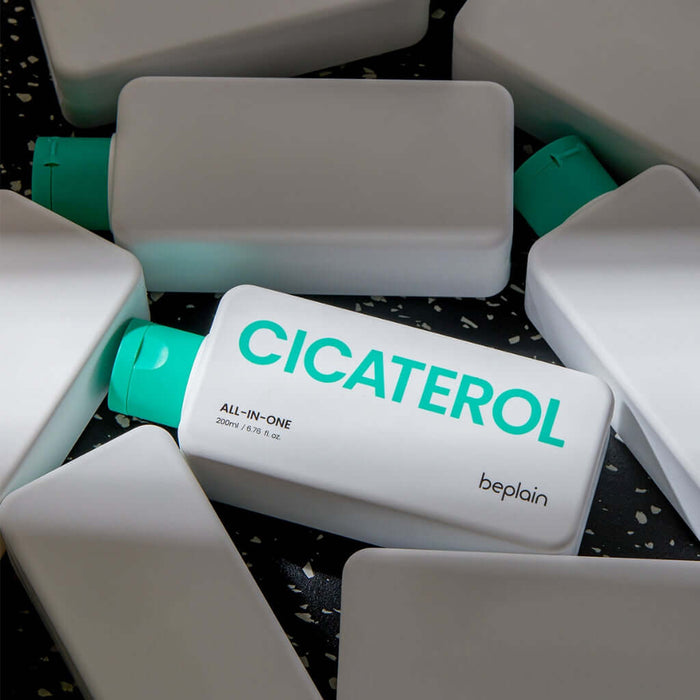 BEPLAIN Cicaterol All-in-one skincare product with green caps displayed on a dark speckled surface, highlighting the brand name.