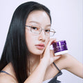 A woman holding a jar of BIO HEAL BOH Probioderm 3D Lifting Cream 50ml, showcasing its packaging against a neutral background.