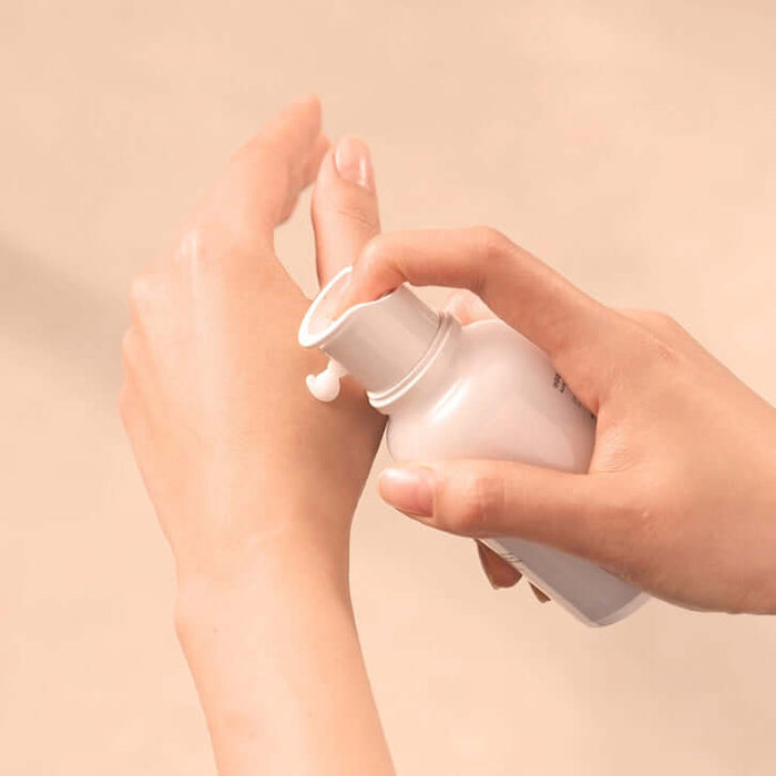 Applying BLESSED MOON Aura Galactomyces Fermented Cream 50ml to hand for skincare