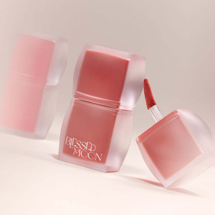 BLESSED MOON Veil Blur Lip Tint in soft focus showcasing trendy container and applicator.