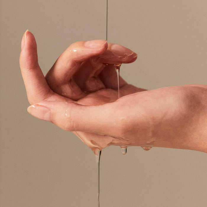 Person applying BRISKIN Exo-Oat Poreless Cleansing Oil 200ml on hands.