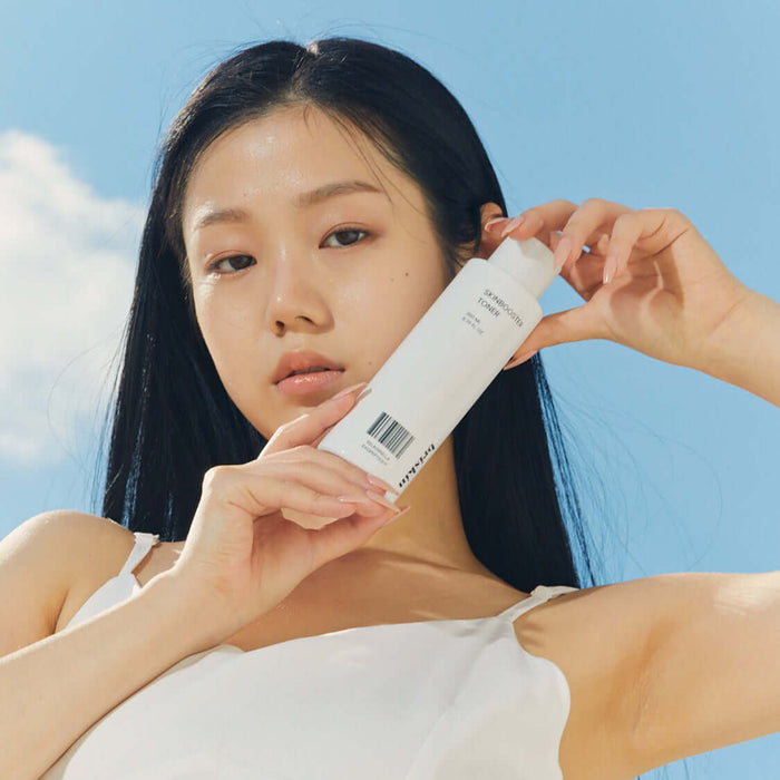 Person holding BRISKIN Selaginella Exopeptide Toner 200ml bottle outdoors