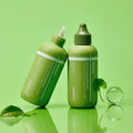 CENTELLIAN 24 Madeca Matcha Toning Peeling Gel 150ml bottles on green background with leaves and clear sphere.