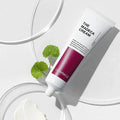 CENTELLIAN 24 The Madeca Cream 50ml tube with glossy background and green leaf, highlighting skincare product features.