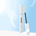COSNORI Long Active Eyelash Serum against a blue sky background with a floating feather.