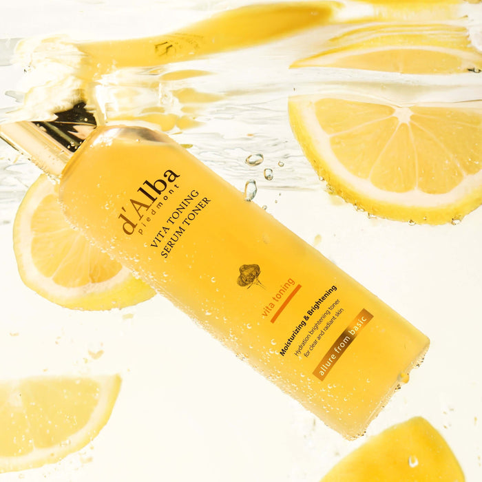 D'ALBA Vita Toning Serum Toner 180ml submerged in water with lemon slices, highlighting fresh and hydrating properties.