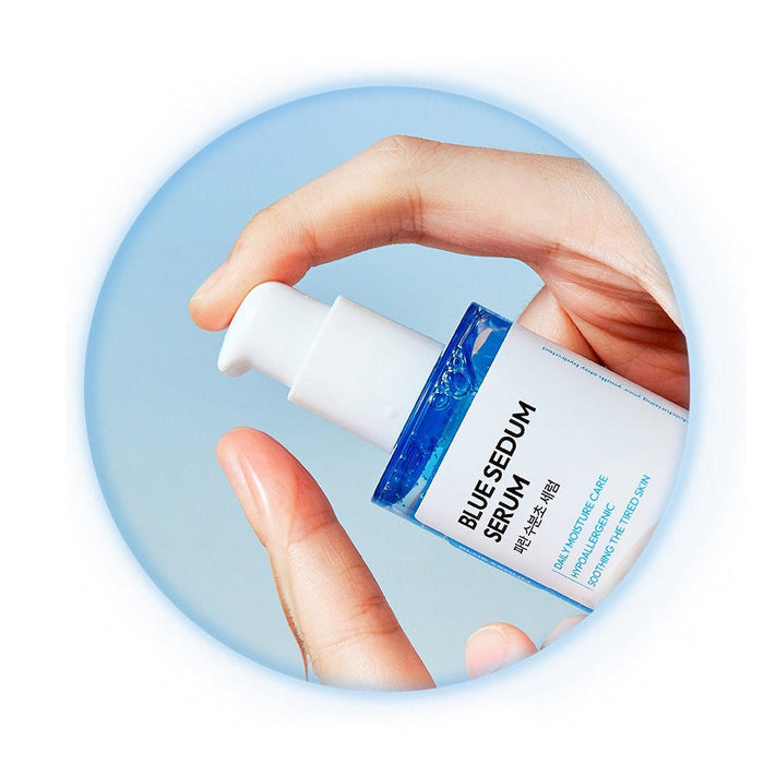 Hand holding DASHU Boy Blue Moisture Serum 65ml bottle against sky background