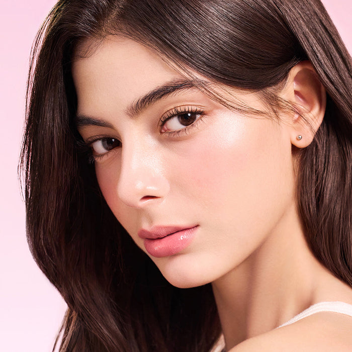 Model wearing DEAR DAHLIA Lip Paradise Sensual Lip Glow with a natural makeup look