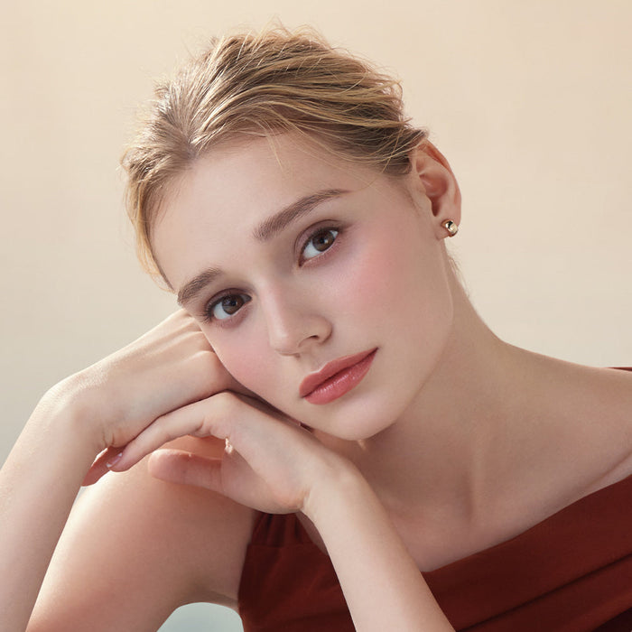 Model wearing DEAR DAHLIA Lip Paradise Sheer Dew Lipstick with soft makeup look