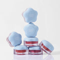 Stack of DEAR MAY Pure Falling Mood Lip Pot 6.5g containers with blue lids and product name visible, designed for mood enhancement.