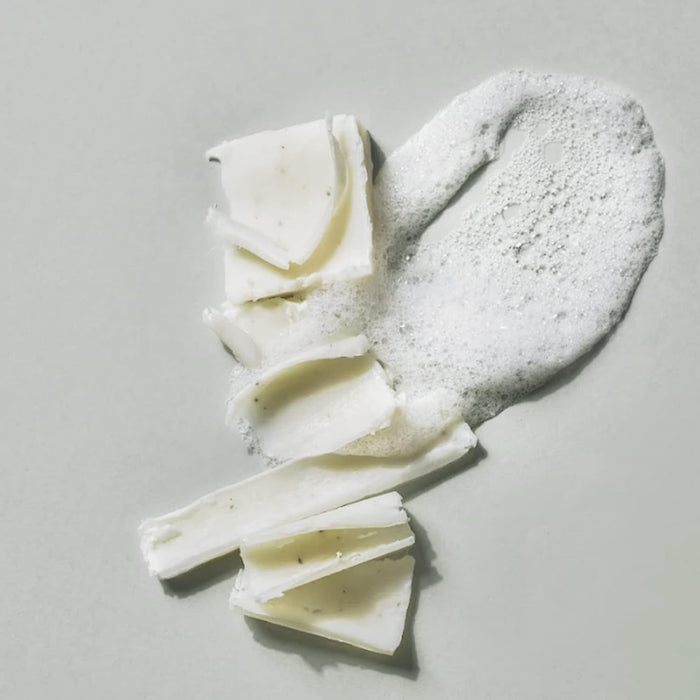 DONGGUBAT Correct Dishwashing Washing Bar 500g with foamy lather on a neutral background.