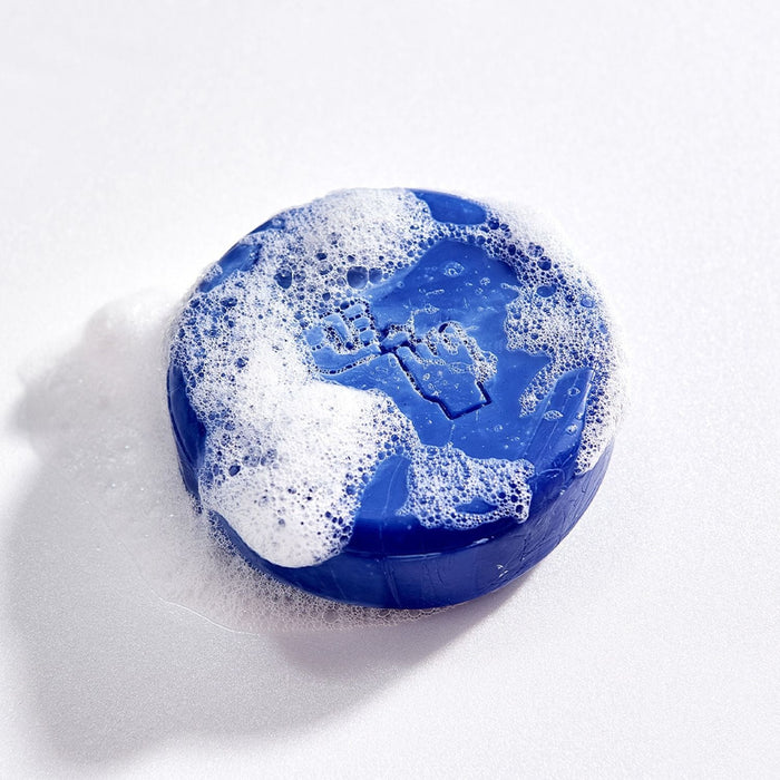 DONGGUBAT Correct Shampoo Bar Cooling with bubbles, blue round soap bar on white background