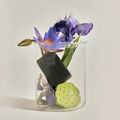 DONGGUBAT Field Blooming Perfume Shampoo Bar Calming 80g displayed in a clear jar with purple and green floral arrangement.