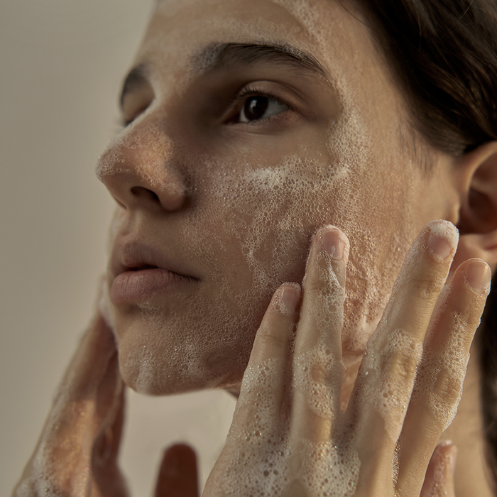 Woman washing face with DONGGUBAT Field Dream Soap Basil for clear skin