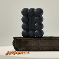 DONGGUBAT Gwalsa Therapy Scrub Shampoo Bar Geocharcoal 95g displayed on natural block with exfoliating beads.