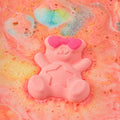DONGGUBAT Happy Moment Bath Bomb Set 2 pieces with colorful teddy bear bath bomb dissolving in water.
