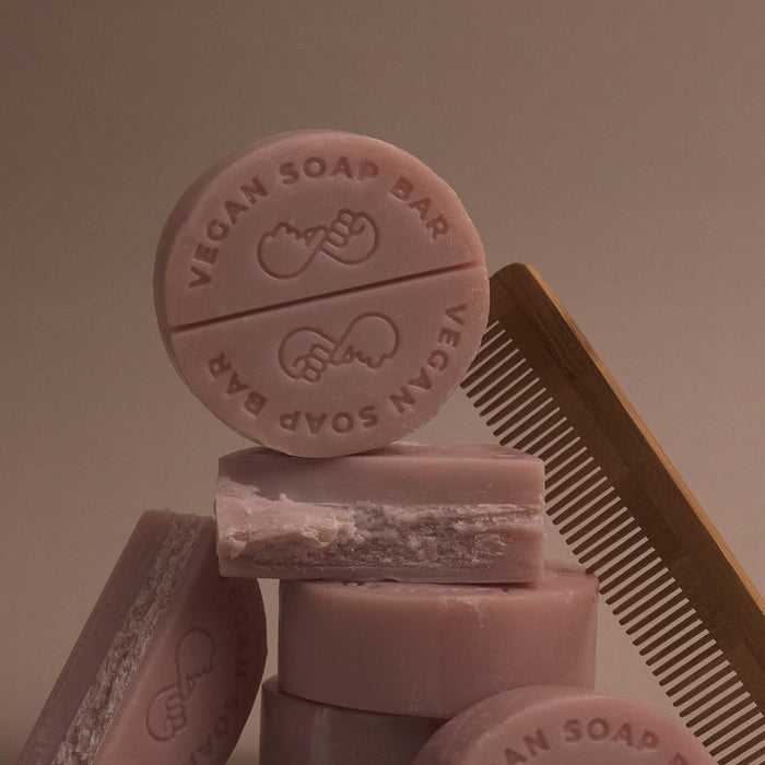 DONGGUBAT Vegan Shampoo Bar Dongbaek stacked with vegan soap bars and a wooden comb in a minimalist setting.