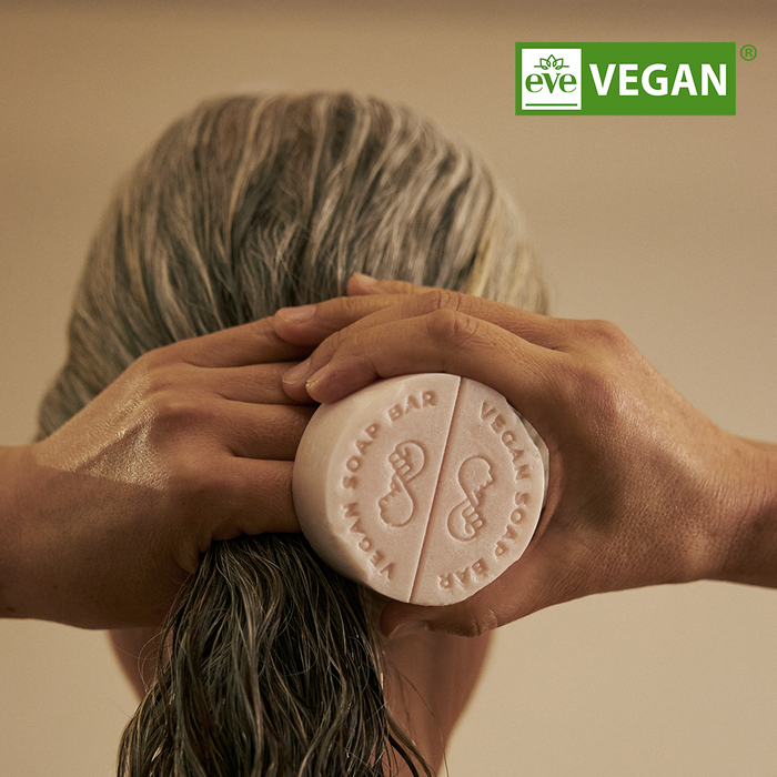 Person using DONGGUBAT Vegan Treatment Bar Dongbaek on wet hair, highlighting eco-friendly and vegan features.