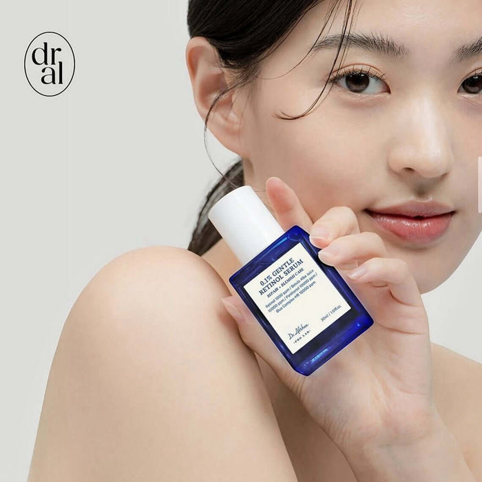 Person holding DR.ALTHEA 0.1% Gentle Retinol Serum 30ml bottle close to face