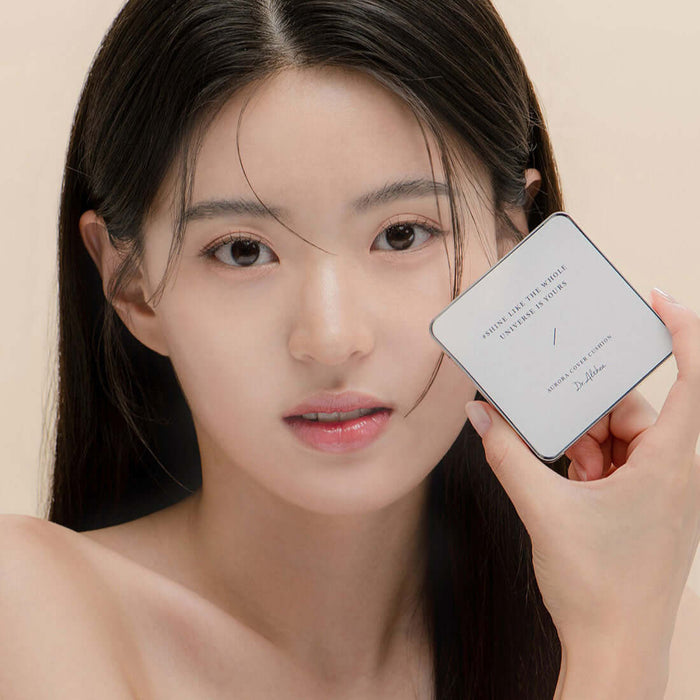 Woman holding DR.ALTHEA Aurora Cover Cushion 15g, showcasing luminous skin finish.