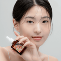 Person holding bottle of DR.ALTHEA Vitamin C Boosting Serum 30ml with clear skin.