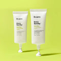 Two tubes of DR.JART+ Every Sun Day Mild Sun 30ml on a green background, showcasing their mild sun protection formula.