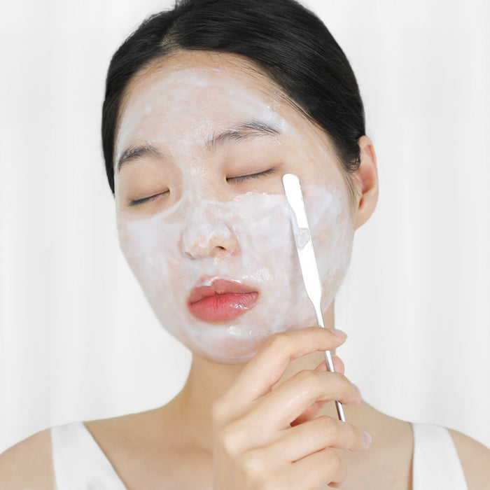 Applying ELIZAVECCA Aqua Water Snail Mushine Cream with a spatula on face for hydrating skincare routine.