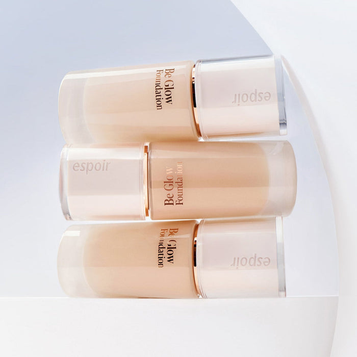 ESPOIR BE GLOW FOUNDATION SPF27 PA++ bottles in a stylish display on a white backdrop.