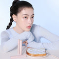 Model posing with ESPOIR EASY BLENDING CONCEALER next to toast on a plate, showcasing skincare and makeup product.