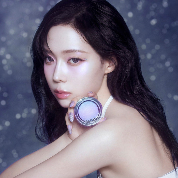 Woman holding ESPOIR Strobing Highlighter [Galaxy Beam Collection] with stars in background