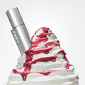 FEEV Hyper-Fit Glam Drop beauty product with rich texture and glamorous design, enhanced by vibrant syrup and whipped cream backdrop.