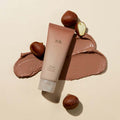 HANYUL Buddle Night Cleansing Pore Pad next to spread cream texture and chestnuts on a beige background