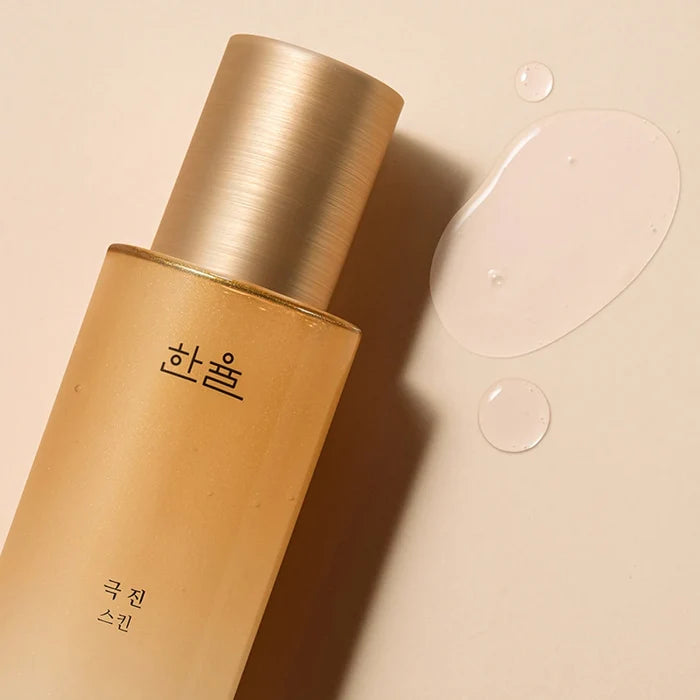 HANYUL Extreme Skin 125ml bottle on beige background with droplets