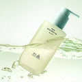 HANYUL Young Artemisia Smooth Cleansing Oil 200ml in a green bottle with a pump, surrounded by swirling oil and bubbles.