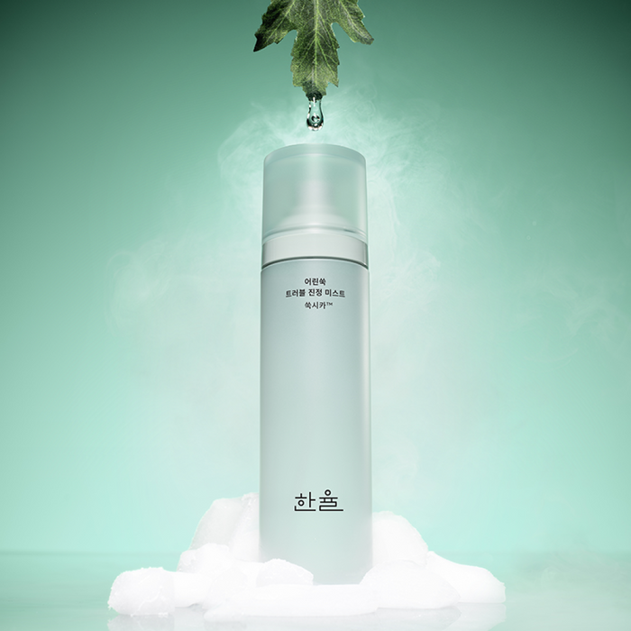 HANYUL Young Artemisia Trouble Mist 120ml product image with green herbal background and water droplet effect.
