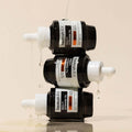 Stacked bottles of HEIMISH RX Multi Vitamin Glow Serum 35ml, showcasing its vibrant formula and sleek packaging design.