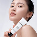 Woman holding HERA Hydro-Dew Plumping Cream 50ml with fresh, glowing skin