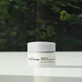 HERBLOOM Kombucha Vegan Collagen Cream 50ml jar on a table with green background.