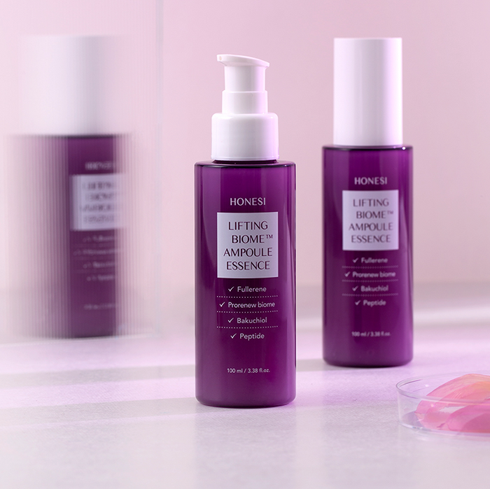 HONESI Ernish Lifting Biome Elasticity Ampoule Essence 100ml on display with focus on packaging design.